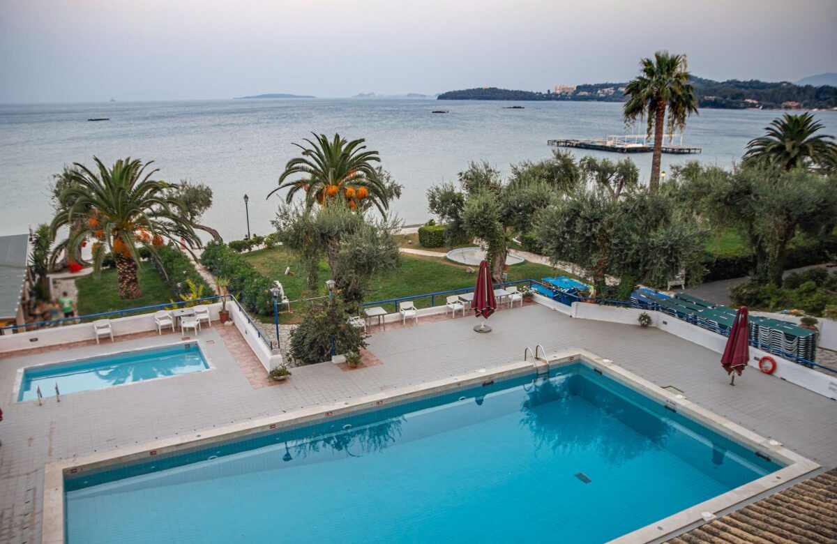 Resort pool framed by palm trees — Lords of the Lands