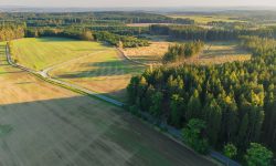 Aerial patchwork of farmland parcels — Lords of the Lands