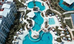 Aerial view of a resort clubhouse and pools — Lords of the Lands