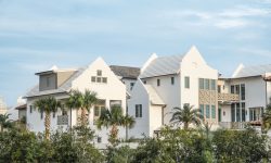 Cluster of modern white villas with palm landscaping in a plotted residential community — Lords of the Lands